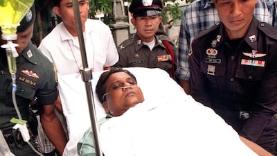 Thai police escort Chhota Rajan to a Bangkok criminal court on September 28, 2000, days after he survived an assassination attempt. Pornchai Kittiwongsakul / AFP