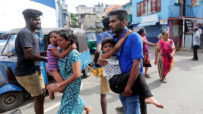 People leave their houses as the military try to defuse a suspected bomb in a van before it exploded. Reuters
