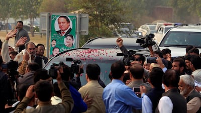 Supporters surround Nawaz Sharif's car as the former prime minister arrives for a court appearance in Islamabad on November 3, 2017. Faisal Mahmood / Reuters