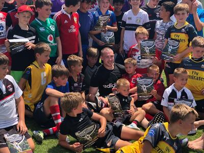 Mike Brown poses for photos with some of the young players from the training session.