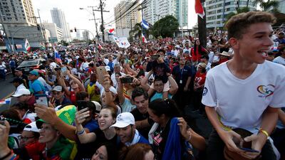 People take pictures with their mobile phones as Pope Francis rides through the streets of Panama City. AP Photo