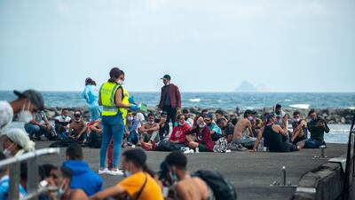 Spanish authorities deal with migrants after their arrival at Orzola's port in Lanzarote, the Canary Islands, on September 26. Photo: EPA