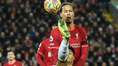 Aston Villa striker Ollie Watkins attempts an overhead kick with Liverpool's Virgil van Dijk in the background. AFP