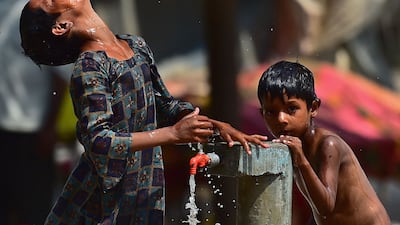 Children use a roadside tap to cool down in Allahabad. AFP