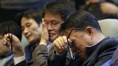 Family members of passengers aboard the sunken ferry Sewol wipe their tears after South Korean lawmakers voted during the plenary session at the National Assembly in Seoul, South Korea. Lee Jin-man / AP