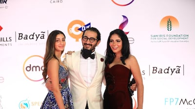 Egyptian actors Ahmed Helmy, centre, and wife Mona Zaki, right, attend the opening ceremony of the 42nd Cairo International Film Festival. EPA