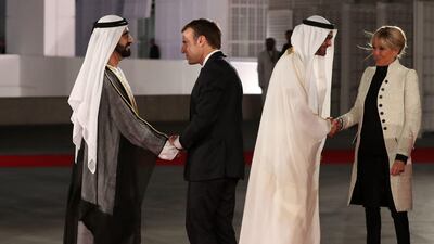 Sheikh Mohammed bin Rashid, UAE Vice President and Ruler of Dubai shakes hands with French president Emmanuel Macron as Sheikh Mohammed bin Zayed, Crown Prince of Abu Dhabi and Deputy Supreme Commander of the UAE Armed Forces greets the president's wife, Brigitte Macron, at the formal opening Louvre Abu Dhabi. Karim Sahib / AFP Photo