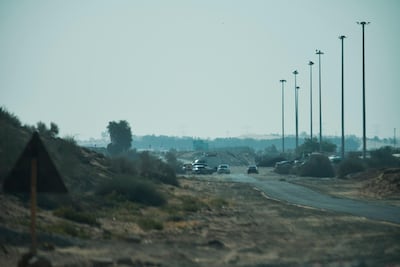Police and flight crash investigation vehicles near the site of the incident in Dubai. AP