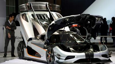 Workers set up a car at the Mazda stand at the China International Exhibition Center during Auto China 2014 in Beijing, on April 20. AFP