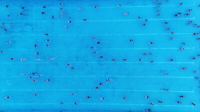 Hundreds of people part in the Sunrise Swim, which marks the first swim of the season, at Brockwell Lido, South London. PA Wire