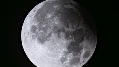 A supermoon with a partial solar eclipse rises over Biegen in Brandenburg, Germany, on Wednesday, September 18. AP Photo