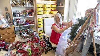 Janet Waite makes Christmas decorations. People are reportedly putting their Christmas trees up early to brighten a dreary year. Antonie Robertson / The National