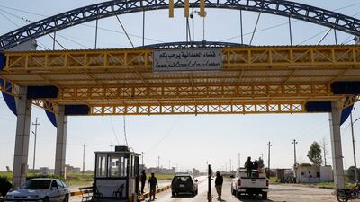 Christian militiamen and police officers stand guard at a gate in Qaraqosh, Iraq. Reuters