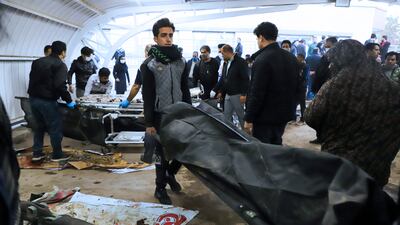 A man carries the body of a victim following the two explosions. AP