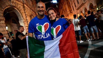 Italy fans celebrate in Genoa.