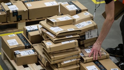 Workers prepare customer orders for dispatch as they work inside an Amazon.co.uk fulfillment centre in Peterborough. AFP