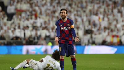 Barcelona's Lionel Messi reacts after fouling Real Madrid defender Marcelo. EPA