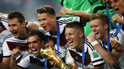 From left, Germany's Miroslav Klose, defender and captain Philipp Lahm, defender Kevin Grosskreutz, midfielder Bastian Schweinsteiger and forward Andre Schuerrle hold the World Cup trophy after their team's victory in the final against Argentina at the Maracana Stadium in Rio de Janeiro on July 13, 2014. Adrian Dennis / AFP