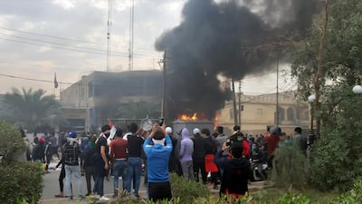 Smoke rises from the office of the Shiite endowment after it was set on fire by protesters during ongoing anti-government protests in Nassiriya, Iraq. Reuters