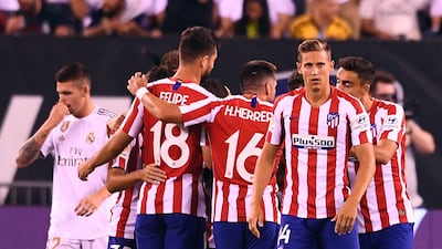 Atletico celebrate their seventh goal against Real. AFP