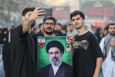 Shia Muslim pilgrims in Iraq hold up a poster of Iran's supreme leader, Mojtaba Khamenei. AFP