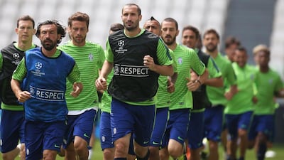 Juventus players Andrea Pirlo and Giorgio Chiellini lead a team jog during their training session on Monday for the Champions League final. Marco Bertorello / AFP