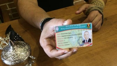 Ahmed Al Amshawi holds his Iraq Amateur Radio Society license. Sofia Barbarani / The National