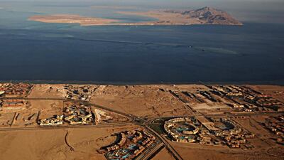 A picture taken through the window of an airplane shows the Red Sea's Tiran (foreground) and the Sanafir (background) islands in the Straits of Tiran between Egypt's Sinai Peninsula and Saudi Arabia. Egypt has agreed to demarcate its maritime borders with Saudi by officially placing the two islands in the Straits of Tiran in Saudi territory. AFP
