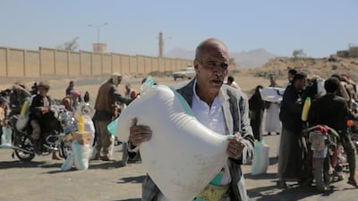 A Yemeni man receives food aid in Sanaa, in February 2023. EPA