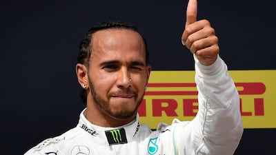 Mercedes driver Lewis Hamilton celebrates on the podium after winning the Formula One Grand Prix de France at the Circuit Paul Ricard in Le Castellet, southern France. AFP