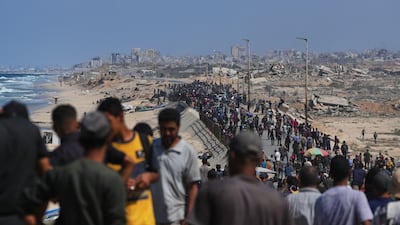 Displaced Palestinians return to Gaza city along the coastal road on Friday after the ceasefire between Hamas and Israel began. AP