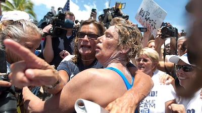 Looking dazed and sunburned, US endurance swimmer Diana Nyad walked ashore yesterday, becoming the first person to swim from Cuba to Florida without the help of a shark cage. J Pat Carter / AP Photo