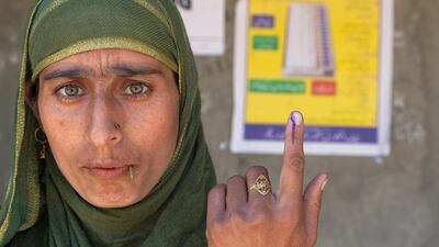 A Kashmiri Muslim woman show her indelible ink marked finger after casting her vote during the sixth phase of Indian parliamentary elections on in Vejbeour 45 km (28 miles) south of Srinagar. (Yawar Nazir / Getty Images / April 24, 2014)