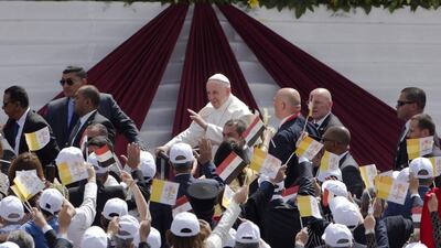 Pope Francis waves as he arrives to celebrate Mass for Egypt's Catholic community at the air defence stadium in Cairo. Amr Nabil / AP