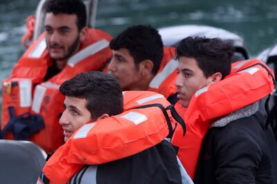 Migrants aboard a Cyprus marine police boat after being rescued from their own vessel off the Mediterranean island. AP