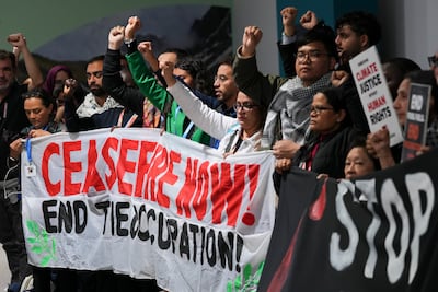 Dozens of people held banners demanding peace and climate justice in the corridors of the Cop29 venue. AP