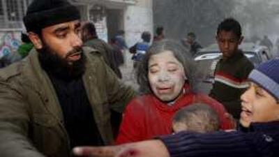 Palestinians evacuate after an Israeli air strike in Gaza City.