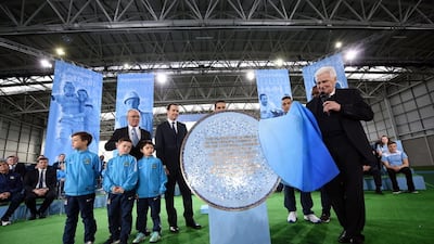 Former Manchester City captain and manager Tony Book unveils a plaque at the launch of the City Football Academy on Monday. AFP