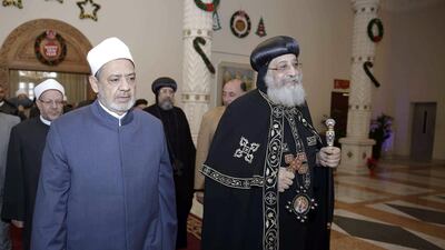 Azhar Grand Imam Ahmed al-Tayeb, left, being received by Egypt's Pope Tawadros II, the Coptic Orthodox Patriarch of Alexandria on the Holy See of Saint Mark, upon the former's arrival at St Mark's Cathedral in the capital Cairo, as the former congratulates the latter ahead of the Coptic Orthodox celebrations of Christmas yet to take place on January 7. AFP