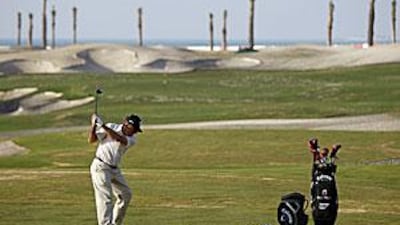Gary Player swings away on the 12th hole of his course at Saadiyat Island.