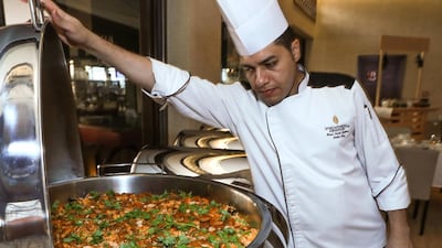 When preparing a mass iftar, preparation and precision is key. This means meat dishes such as the ouzi need to be marinated and placed in the oven four hours prior to have it ready to be served. Victor Besa / The National