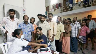 Indian workers get their blood pressure checked at a free clinic set up at a Mussafah labour camp. Stephen Lock / The National