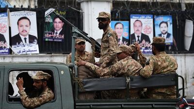 Pakistani soldiers outside a voting centre the day before the election. Wakil Kohsar / AFP