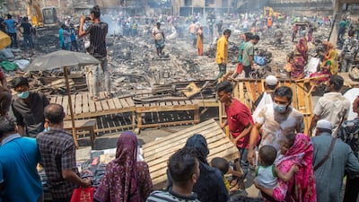 Bangabazar traders set up makeshift stalls on a footpath after fire ripped through the clothing market in Dhaka, Bangladesh. EPA