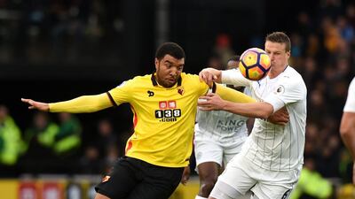 Troy Deeney of Watford holds off a challenge from Robert Huth of Leicester City. Tony Marshall / Getty Images