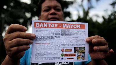 A Filipino villager living along the slopes of rumbling Mayon Volcano displays a notice to vacate in Legaspi city, Philippines. Francis R. Malasig / EPA