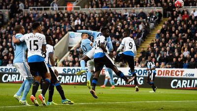 Manchester City striker Sergio Aguero, centre, heads in the opening goal. Stu Forster / Getty Images