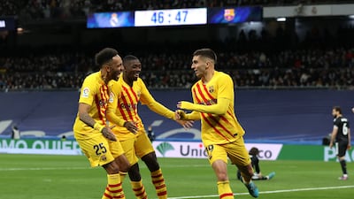 Ferran Torres celebrates with Pierre-Emerick Aubameyang and Ousmane Dembele after scoring Barcelona's third goal in their 4-0 win against Real Madrid at the Santiago Bernabeu on March 20, 2022. Getty
