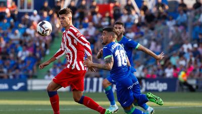 Atletico's Alvaro Morata battles with Getafe midfielder Mauro Arambarri. EPA