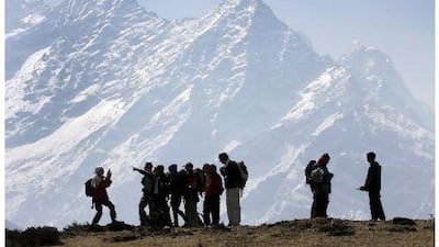 Trekkers pause to admire Mt Kusum Kangru in Nepal. Reuters